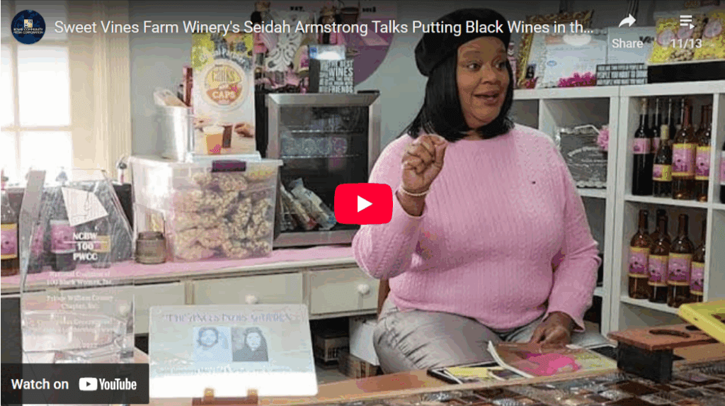 Woman in winery discussing wine products.