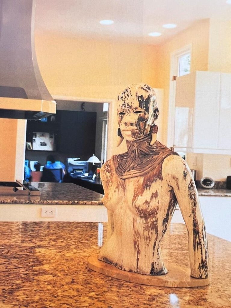 Wooden sculpture on a kitchen countertop.